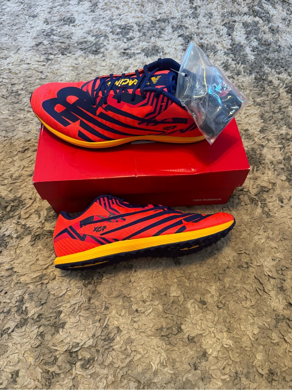 New Balance Red Navy Yellow XC7 running shoes with spikes
